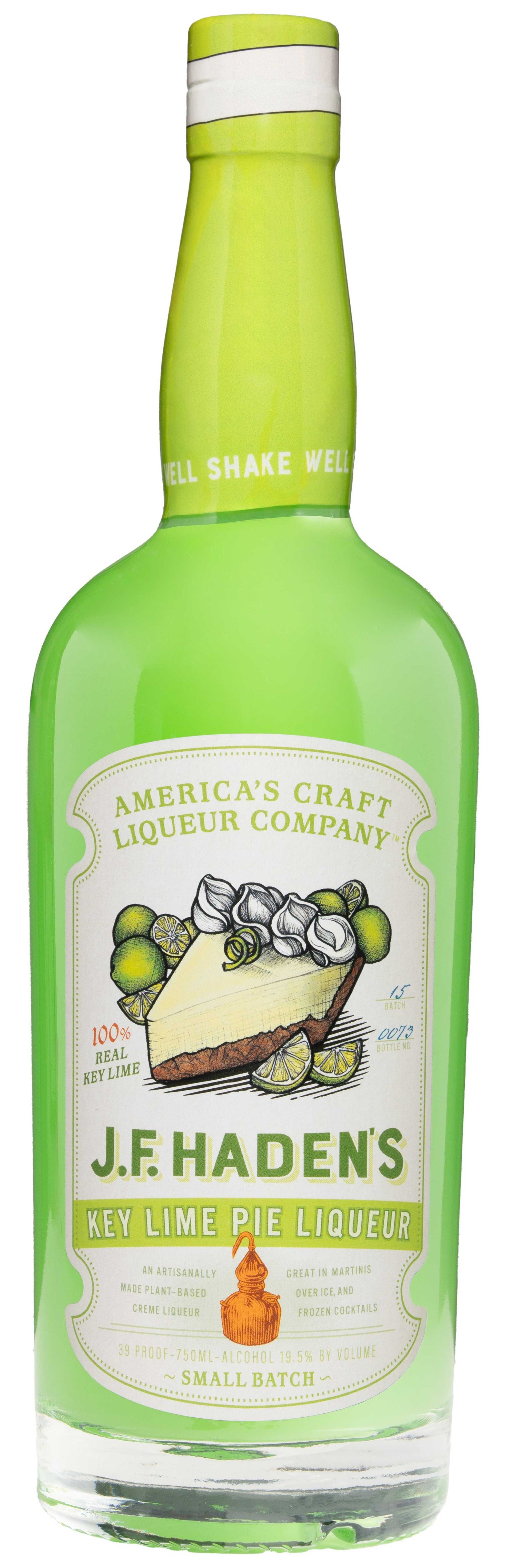 J.F. Haden's Key Lime Pie Liqueur bottle with tropical key lime slice on wooden surface